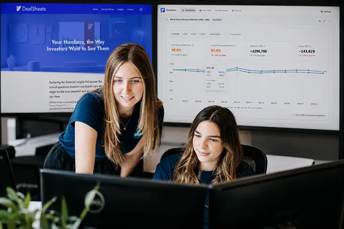 Two staff looking at a screen
